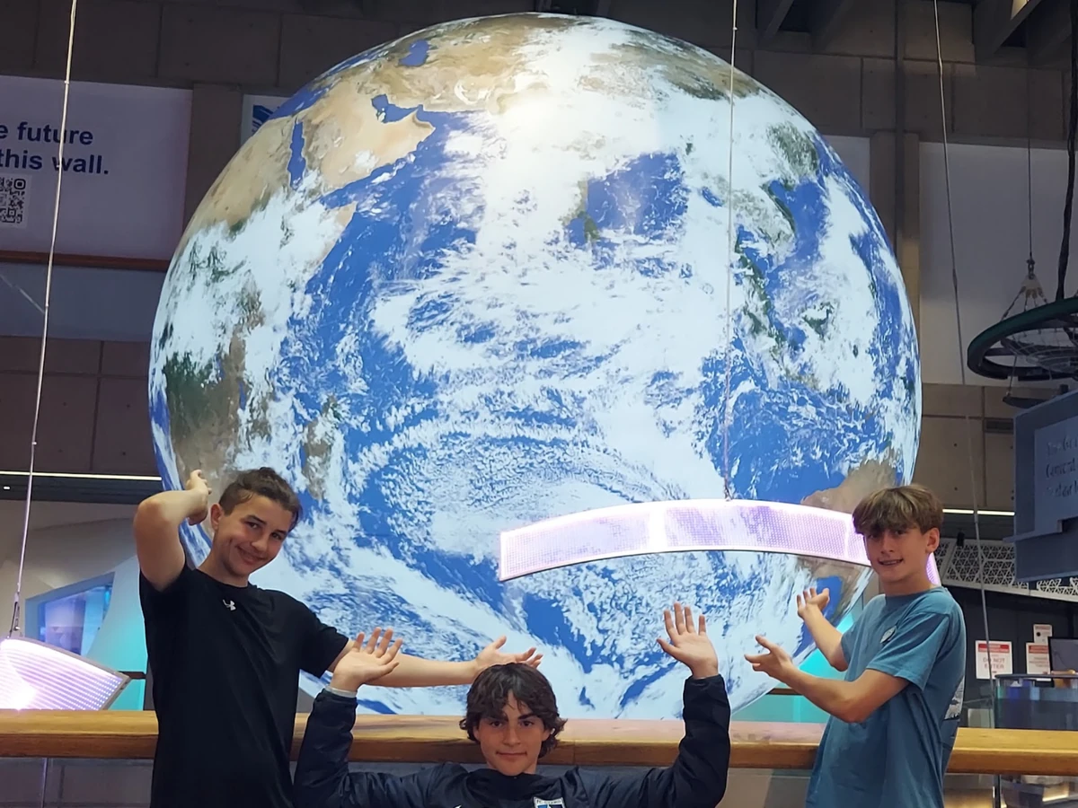 Landmark students in front of the suspended Earth globe at the Museum of Science in Boston