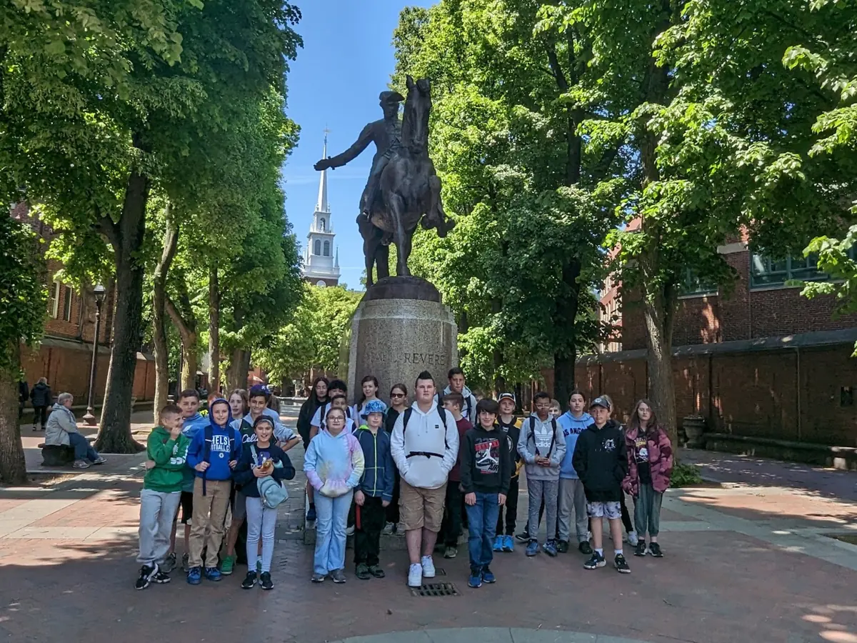 A Landmark student group at the Paul Revere statue with the Old North Church spire behind, on Boston's Freedom Trail