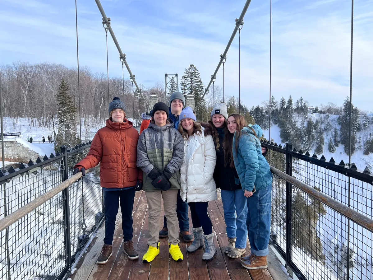 Students on the suspension bridge above Montmorency Falls near Quebec City in winter