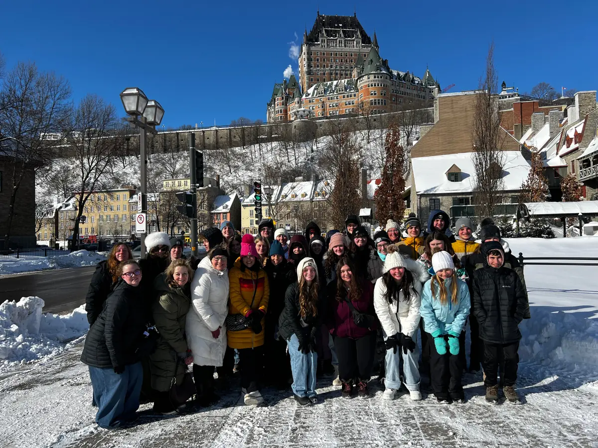 A Landmark student group in Old Quebec in winter, with the Château Frontenac above