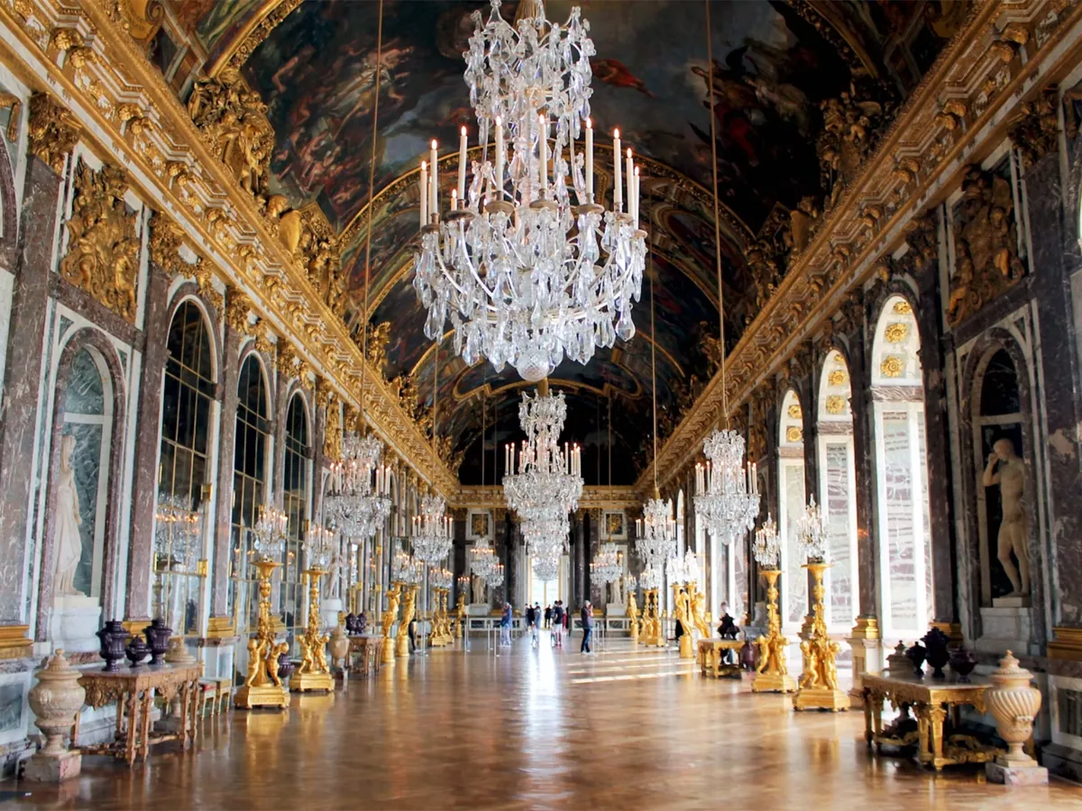 The Hall of Mirrors at the Palace of Versailles, with chandeliers and gilded decoration
