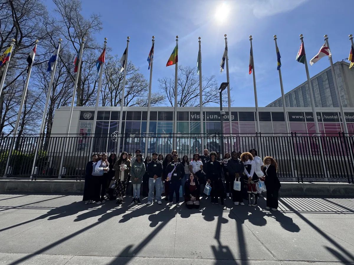 A Landmark school group outside the United Nations headquarters in New York City with member state flags flying behind them