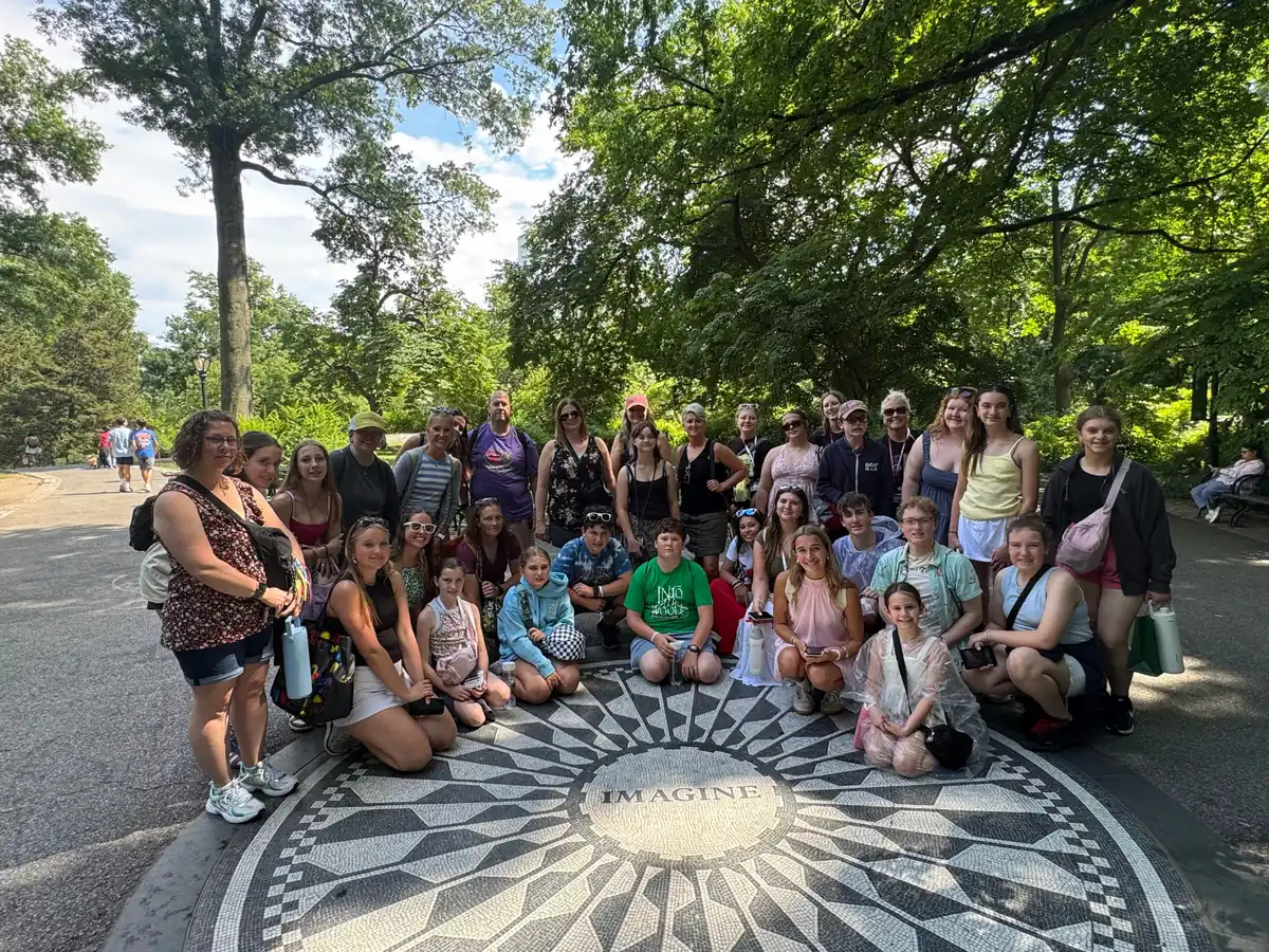 A Landmark school group with teachers and chaperones at the Imagine mosaic in Central Park, New York City