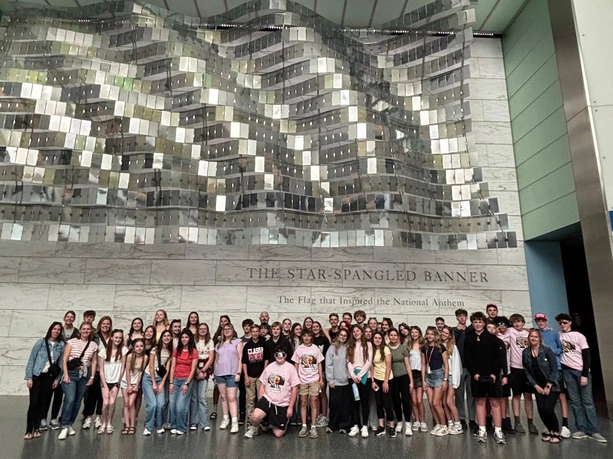 A large Landmark student group in the Star-Spangled Banner hall at the Smithsonian National Museum of American History
