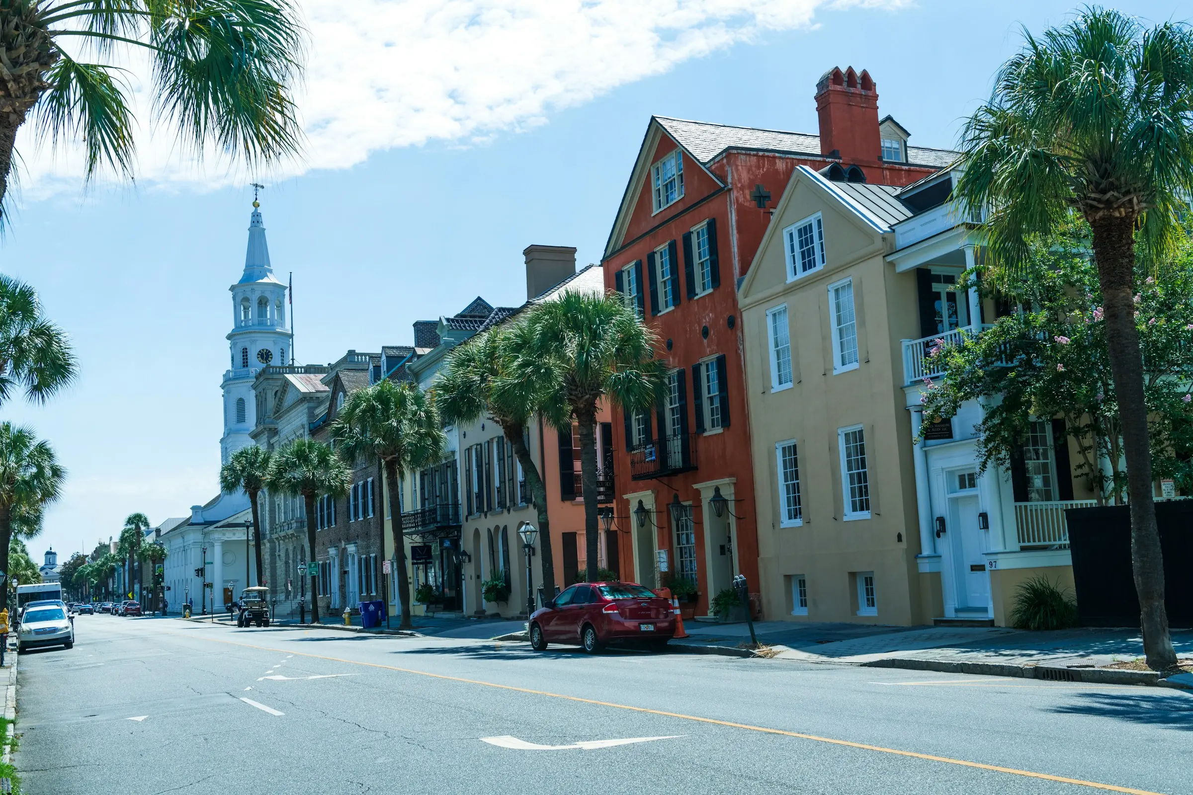 Historic Broad Street in Charleston, South Carolina, with St. Michael's Church steeple and palmetto trees