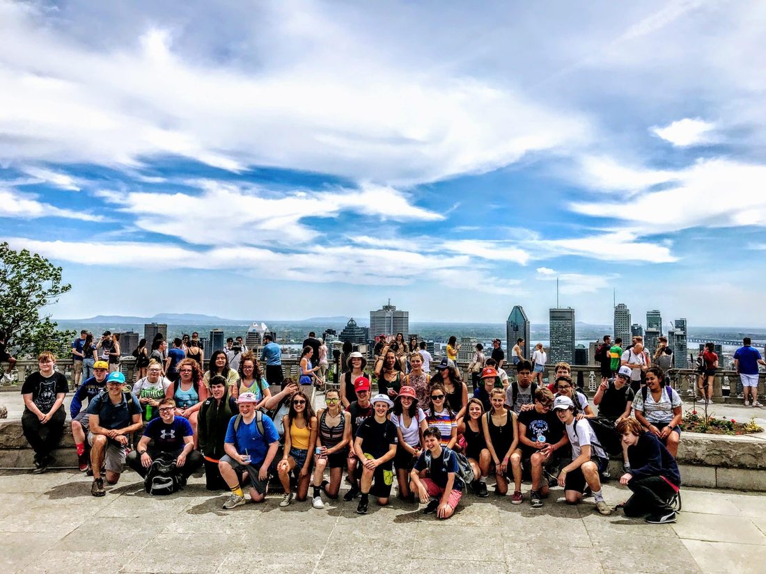A Landmark student group at the Mount Royal lookout above the Montreal skyline