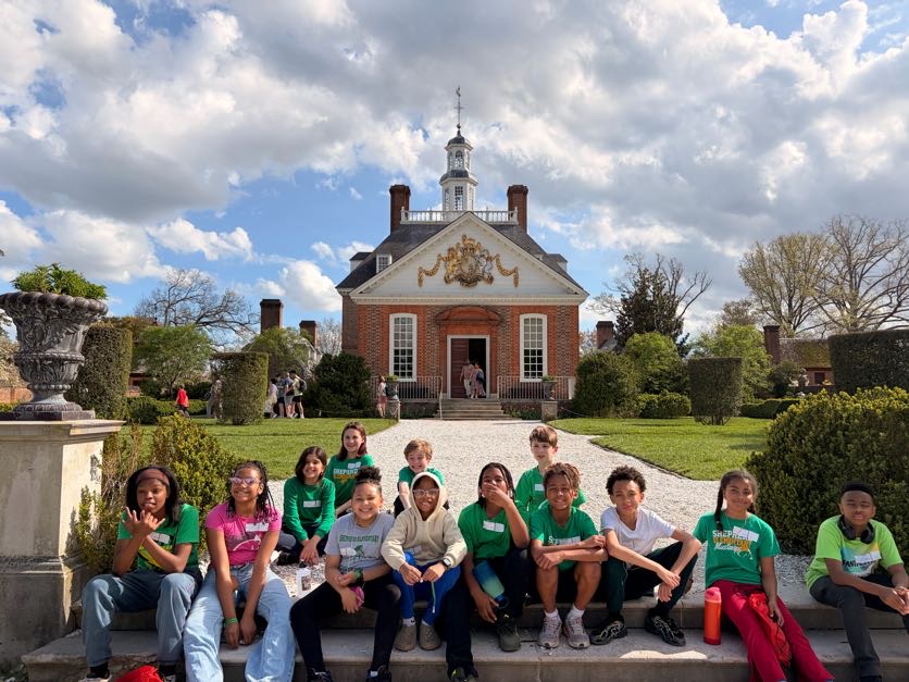 A Landmark student group seated in front of the Governor's Palace in Colonial Williamsburg