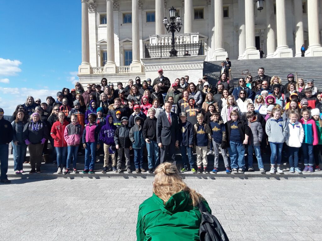 Students taking a group photo at the United States Capitol Building