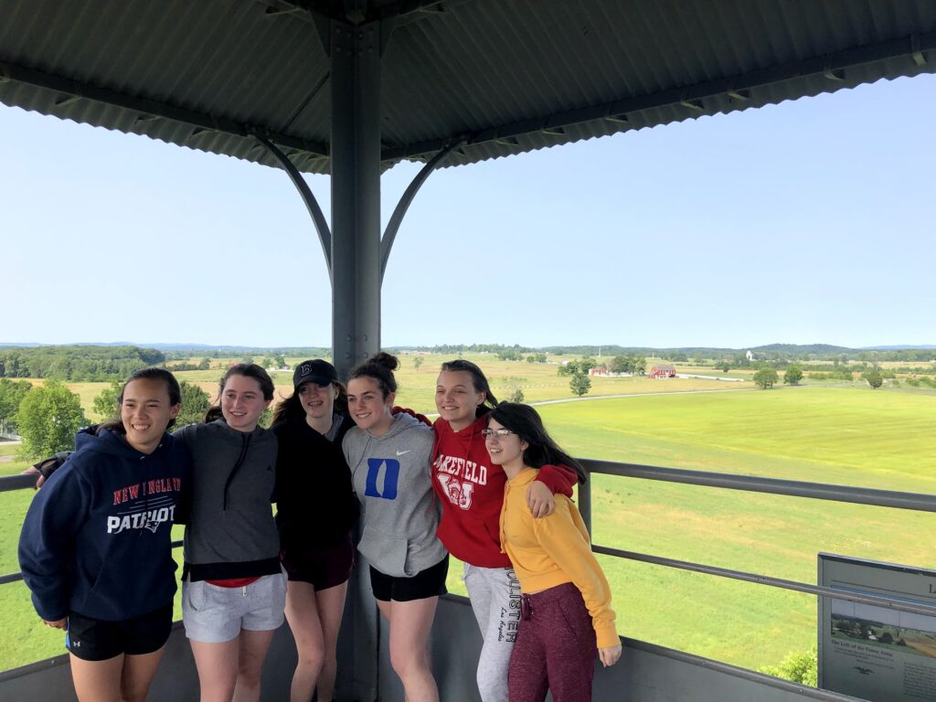 Students in Gettysburg, PA with the battlefields in the background.