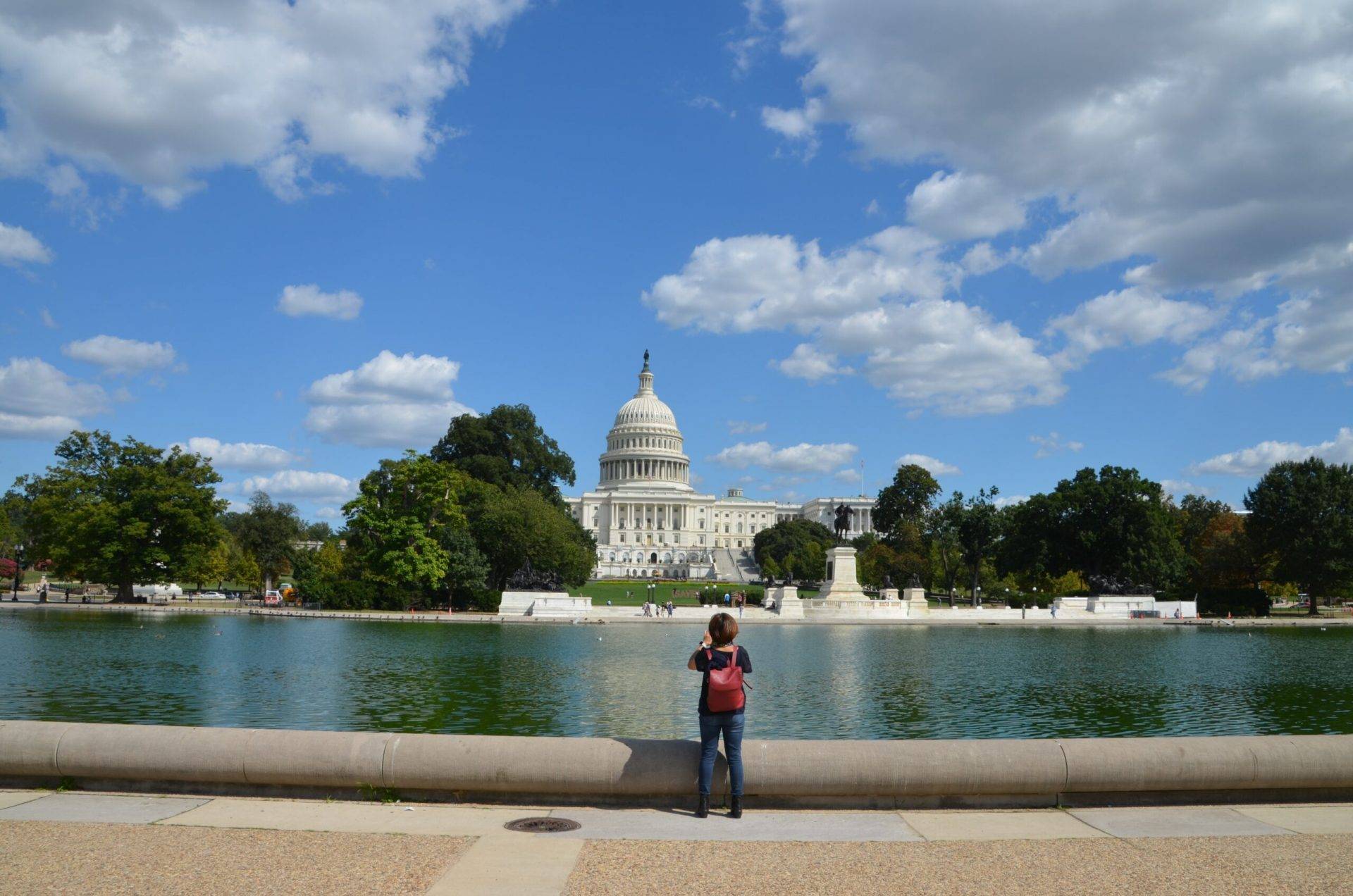 Student taking a picture of the United States Capitol Building in Washington, DC on a school trip