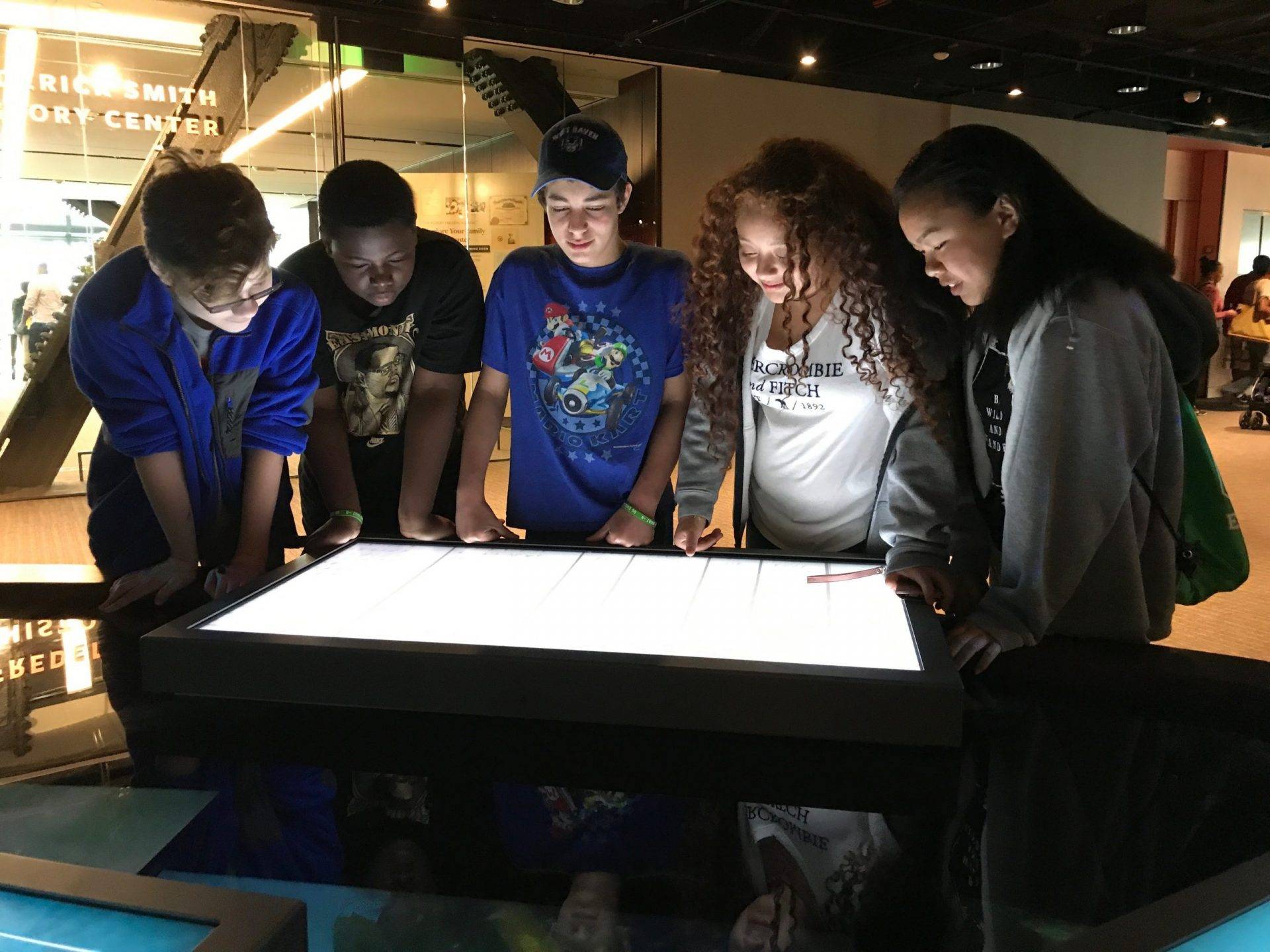 Students around a interactive screen at a museum in DC