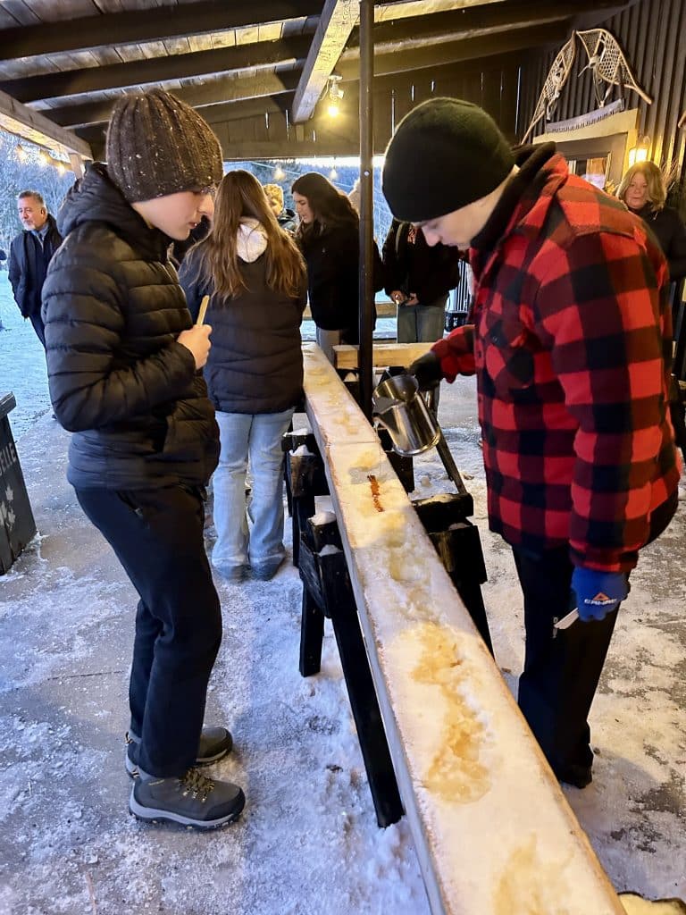 Students enjoying maple taffy on ice