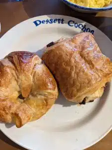 a croissant and a chocolatine on a plate