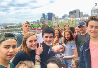 students gathered with the montreal skyline background