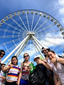students in front of the big wheel in old montreal
