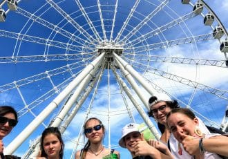 students in front of the big wheel in old montreal