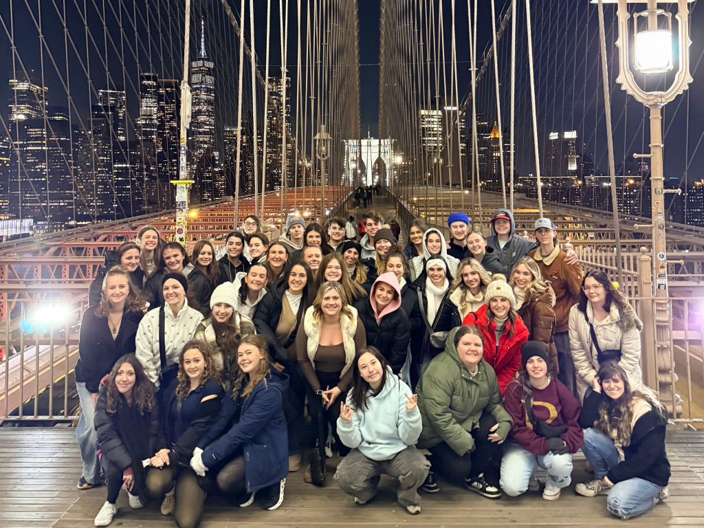 A group of people posing for a photo on a bridge during their Landmark Educational Tours Registration.