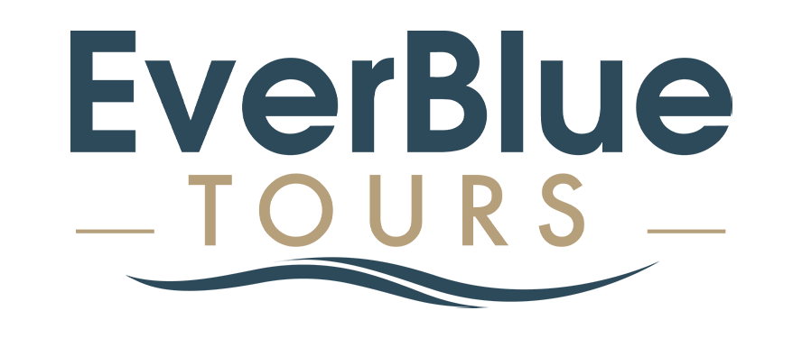 Logo for "EverBlue Tours" with "EverBlue" in large blue letters and "TOURS" in smaller tan letters beneath, flanked by tan lines and a blue wave graphic below, perfect for Landmark Educational Tours.