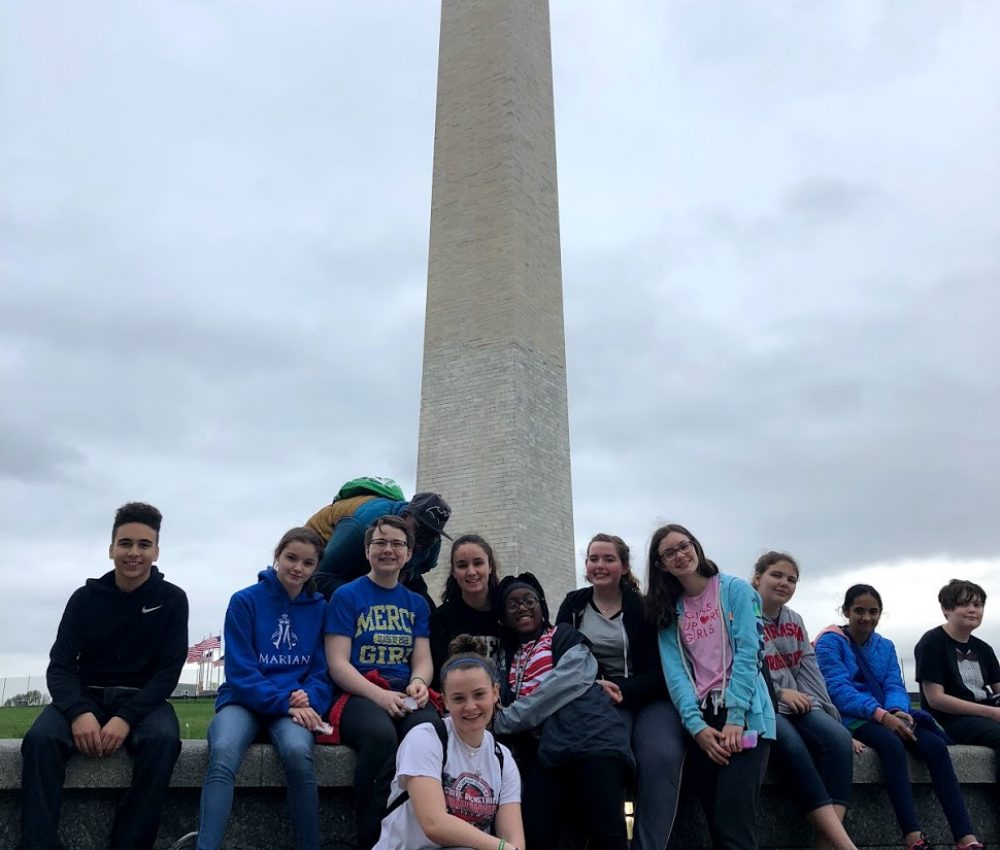 Student group taking a picture with the Washington Monument in Washington, DC